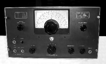 Gray tabletop receiver with large dial and 7 knobs