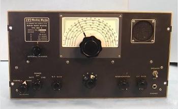 Gray tabletop receiver with large slide-rule dial and 7 knobs