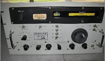 Rack-mount 1960s? receiver with a light gray front, slide-rule dial, meter and 8 knobs 
