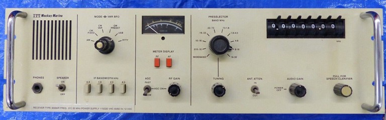 Light  beige receiver 5 inch by 19 inch with thumb-wheel switches to set frequency, S-Meter, speaker, and 6 knobs