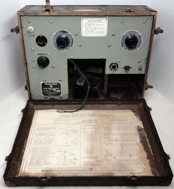 Radio transmitter with 4 knobs in a wood case with a foldtout cover