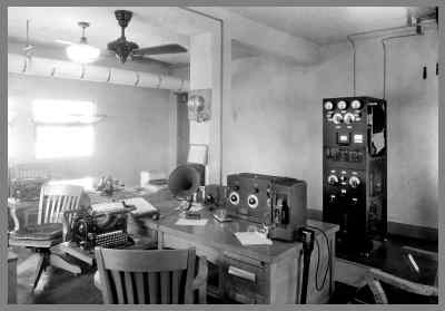 Another view of the later WUG2 radio room with transmitter in the background and operators desks (and receiver) in the foreground.