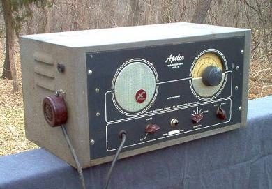 Tabletop radio transceiver with a big round speaker grill on left front and a round dial on the right and 3 knobs below.