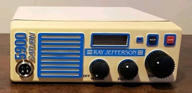 Small VHF FM unit with 3 knobs, channel? indicator window, microphone jack and front mount speaker.