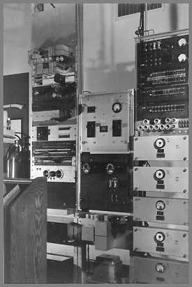 Three open relay racks filled with gear.