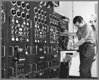 Four of the "new" transmitters showing in 6' racks with a rack of misc. gear at the rear.